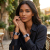 Woman wearing a black shirt and acupressure bracelets with a blurred outdoor background