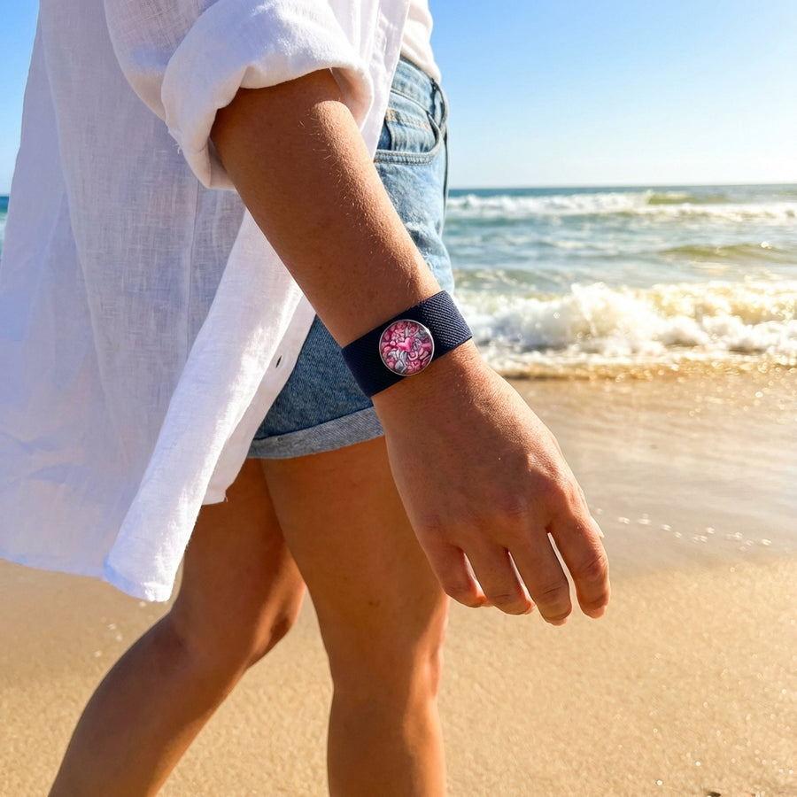 Person wearing a fidget charm AcuBracelet at the beach